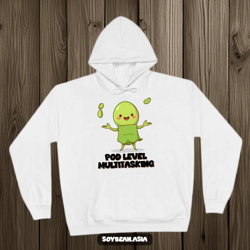 Funny edamame pod character in a green apron, skillfully juggling beans on a warm, comfortable hoodie, chef-inspired humor.